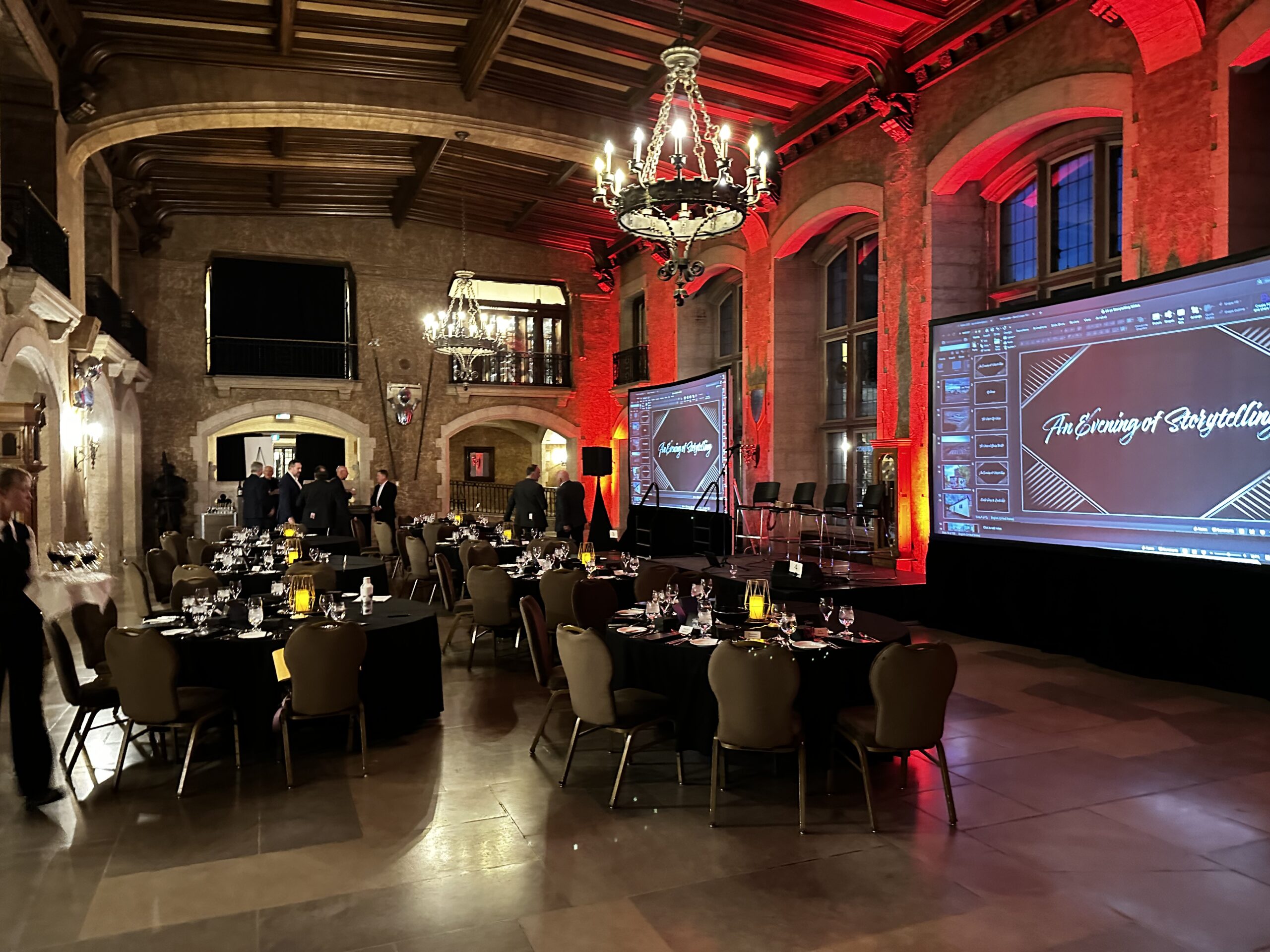 an indoor charity gala with people wearing formal attire